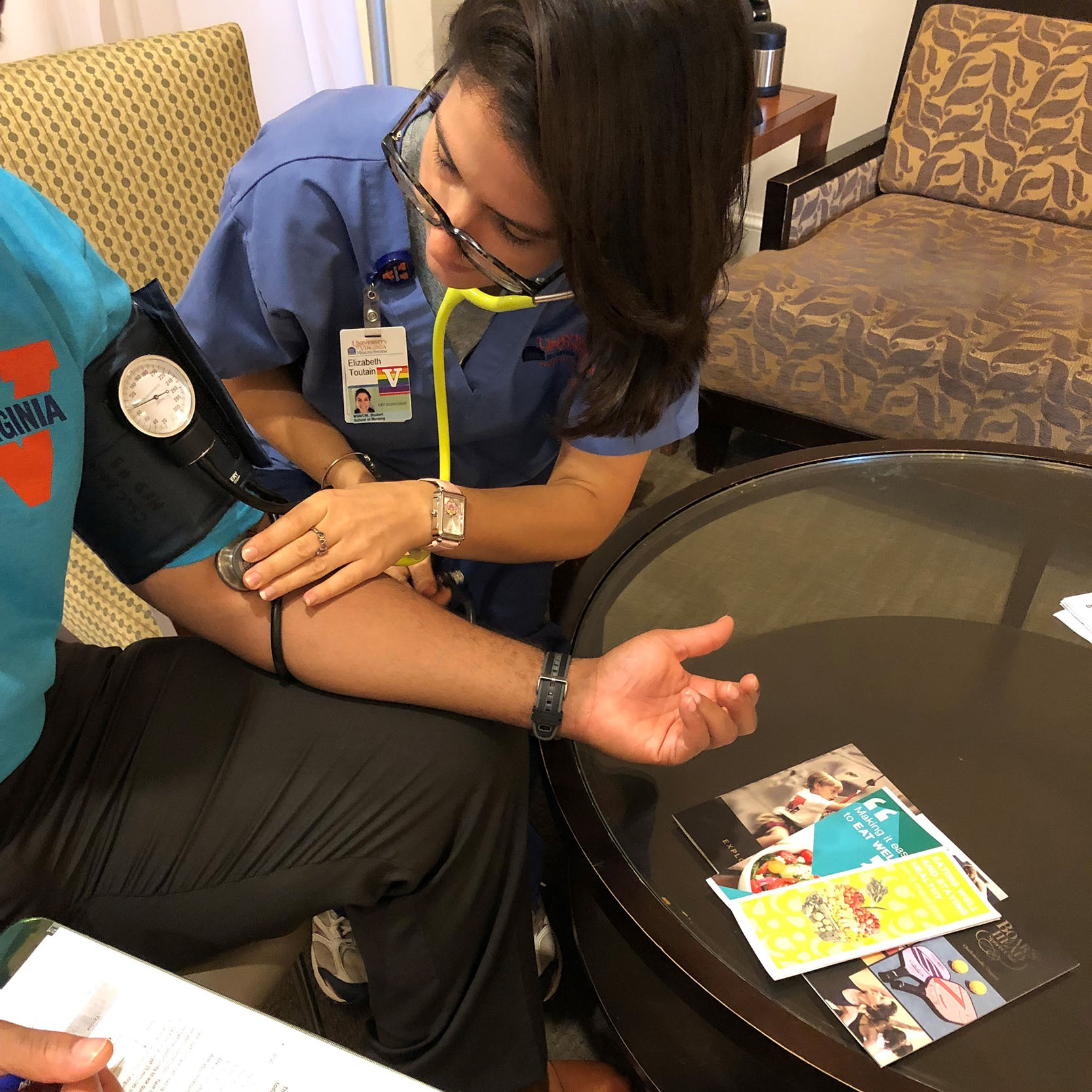 UVA Nursing CNL student Elizabeth Toutain taking a patient's blood pressure