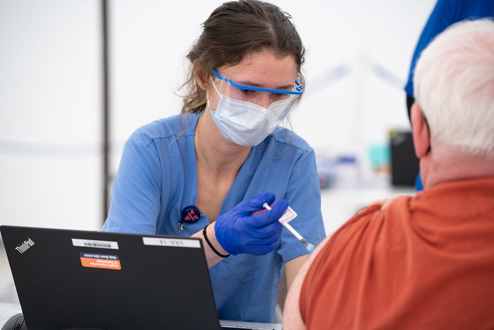 BSN student Nichole Heon vaccinates a community member at a UVA Health BRHD Clinic.