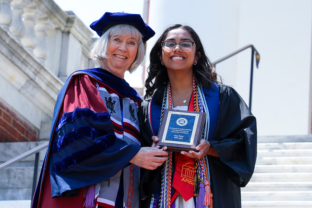 BSN Class of 2023 graduate Zoya Zahid earns an award at graduation from Dean Baernholdt.