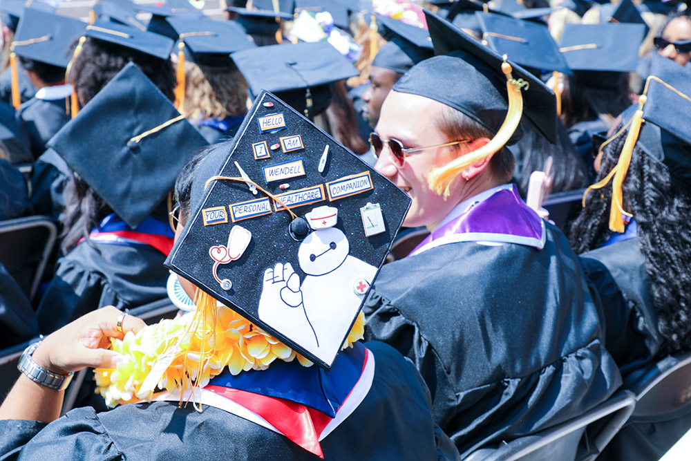 Graduates in the BSN Class of 2023 with decorated mortar boards.