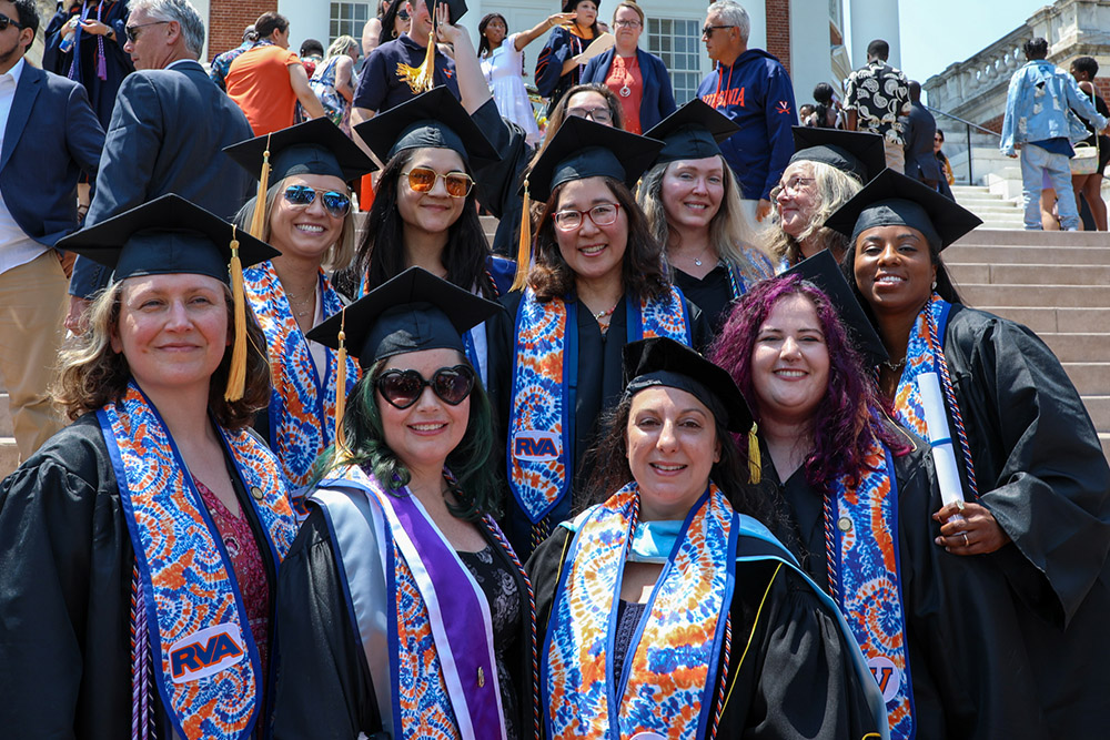 Graduates in the nursing class of 2023 stand on the Rotunda steps with professor Crystal Toll.