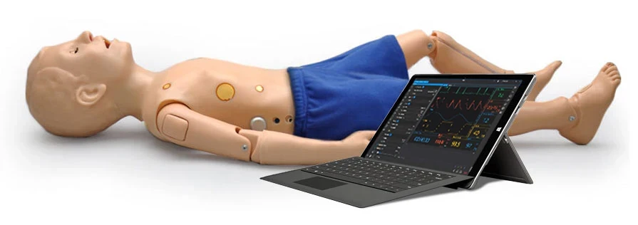 A manikin lying on its back wearing blue shorts with a tablet computer next to it.