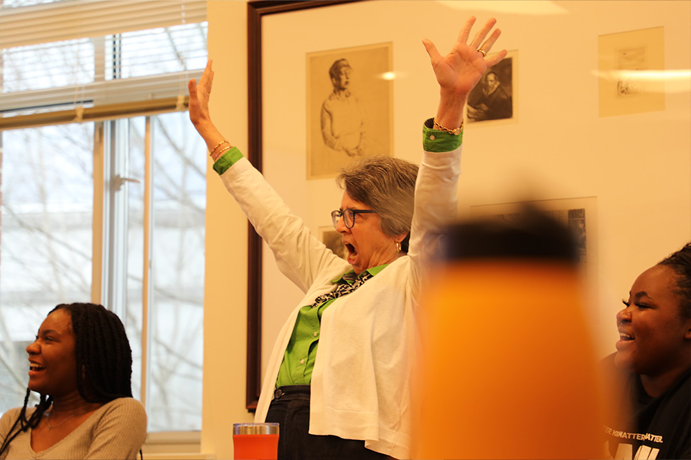 Senior assistant dean of students Theresa Carroll celebrates in class