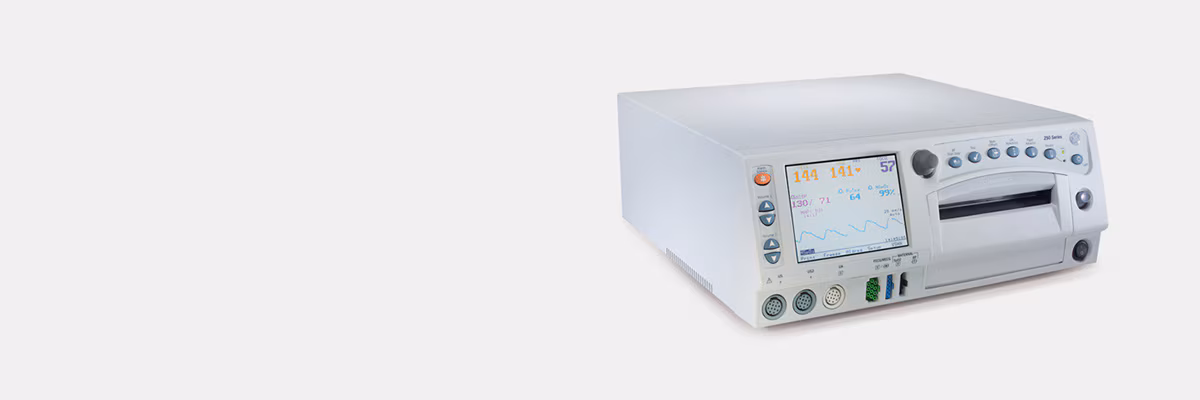 A compact medical device with a white casing, multiple ports on the front, and a power button.