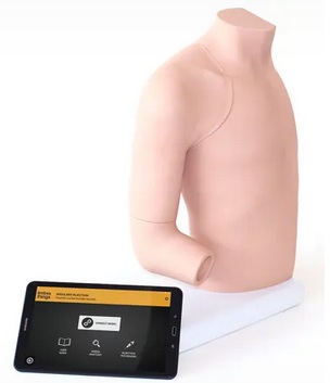 a manikin torso with an arm bending its elbow for injections with a computer placed adjacent to the torso